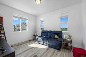 Living area featuring light wood-style floors and healthy amount of natural light