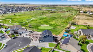 View of property location featuring nearby suburban area, a mountain backdrop, and a local golf course