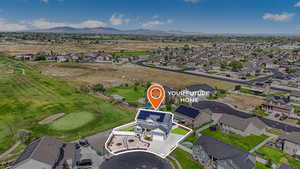 Aerial overview of property's location with nearby suburban area and a mountain backdrop