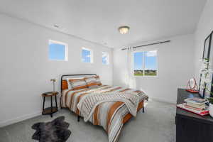 Carpeted bedroom with baseboards