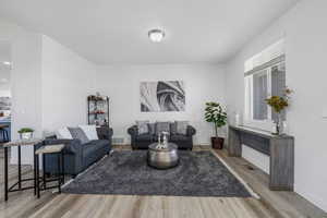 Living room with light wood-style floors and baseboards