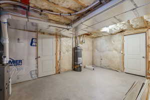 Unfinished below grade area featuring secured water heater