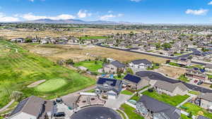 Aerial view of property's location with nearby suburban area and a mountainous background