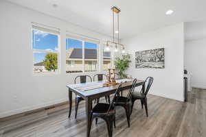 Dining area featuring light wood finished floors and recessed lighting