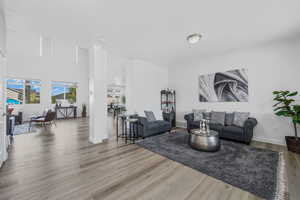 Living room featuring light wood-style flooring and baseboards