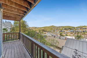 Wooden deck with a mountain view and a residential view