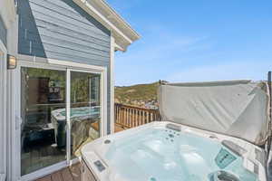 Wooden deck featuring a hot tub