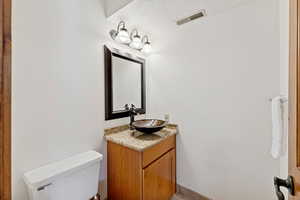 Bathroom with vanity and a textured ceiling
