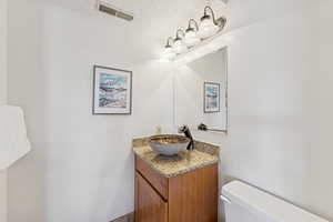 Bathroom with vanity and a textured ceiling