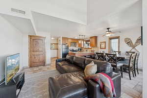 Living area with a textured ceiling and light stone finish floors