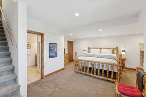 Carpeted bedroom featuring recessed lighting and tile patterned flooring