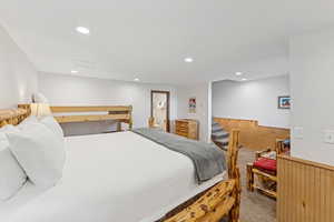 Carpeted bedroom featuring recessed lighting and connected bathroom