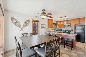 Dining room with a textured ceiling and a ceiling fan