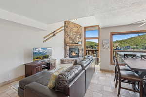 Living room featuring a textured ceiling and a fireplace
