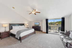 Bedroom featuring light carpet, access to exterior, vaulted ceiling, a ceiling fan, and a textured ceiling