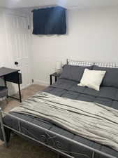 Bedroom featuring light carpet and a closet