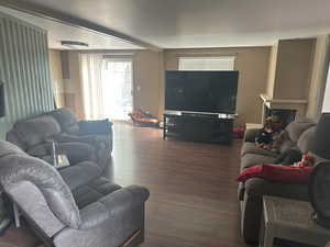 Living room with wood finished floors and a fireplace