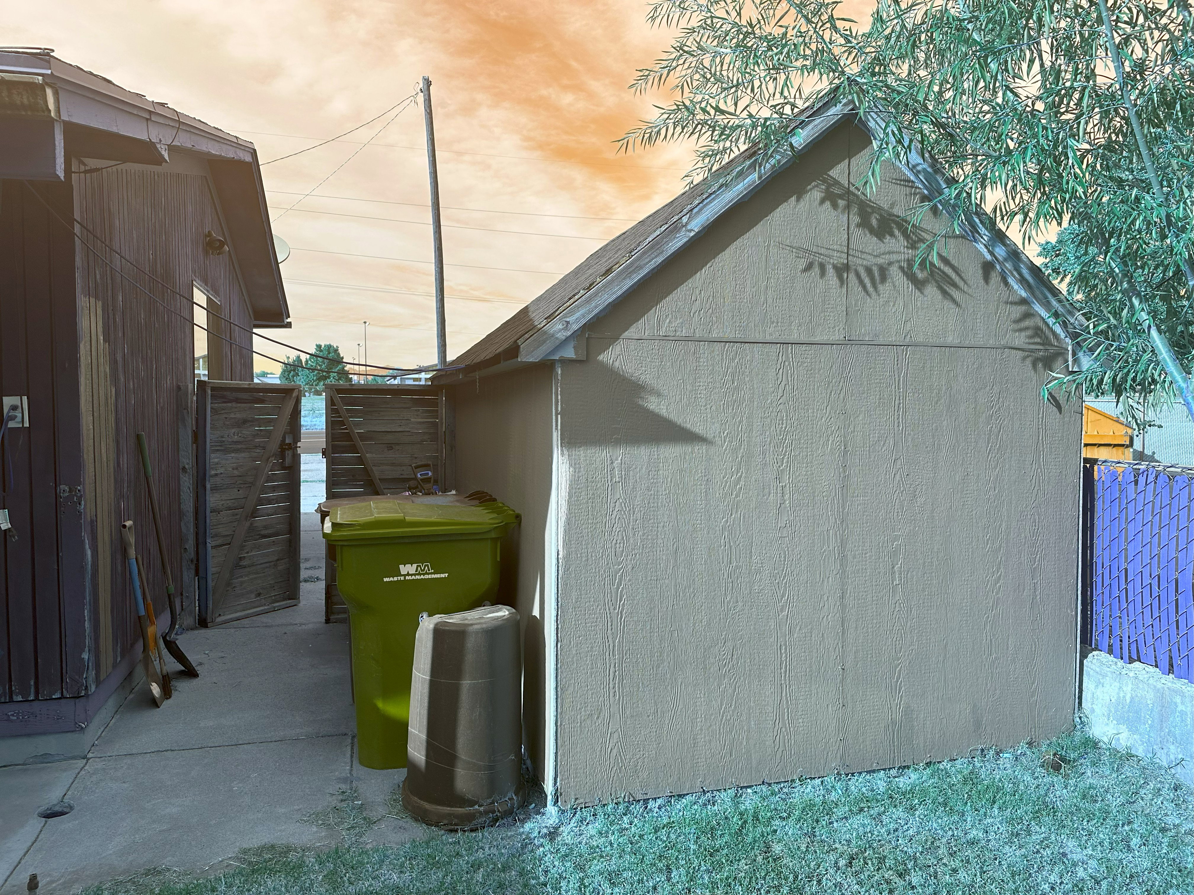 View of side of home featuring an outdoor structure
