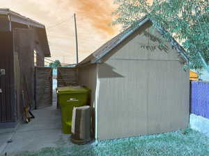 View of side of home featuring an outdoor structure