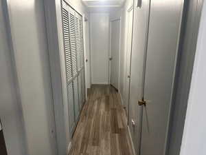 Hallway featuring dark wood-type flooring and baseboards