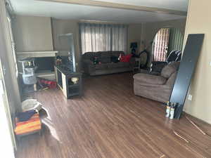 Living area with dark wood-style floors and plenty of natural light