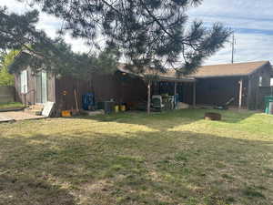 Rear view of property with a yard and a patio