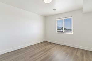 Spare room featuring light wood-style floors