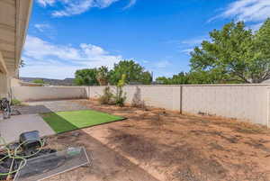 Fenced backyard with a patio area