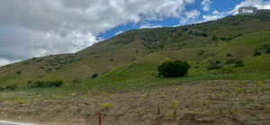 View of mountain backdrop with rural landscape