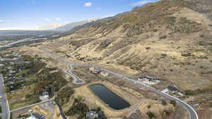 Aerial view of property and surrounding area with a water and mountain view