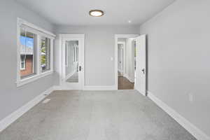 Unfurnished room featuring carpet floors and baseboards