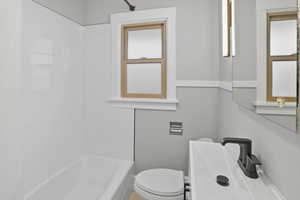 Full bath featuring bathing tub / shower combination and toilet