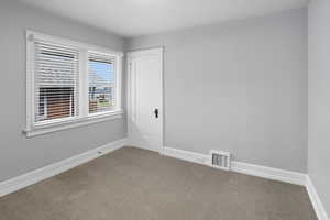 Unfurnished room featuring baseboards and carpet floors