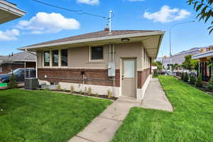 View of front of house featuring brick siding, stucco siding, and a shingled roof