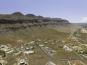 Aerial overview of property's location with a mountainous background and property parcel outlined