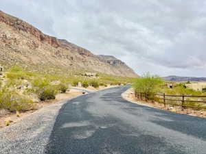 View of asphalt road featuring a mountain view and a view of countryside