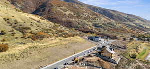 Aerial view of property's location featuring a mountainous background