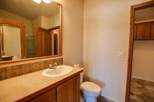 Bathroom with vanity and dark stone finish flooring