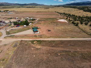 Aerial overview of property's location with rural landscape and mountains