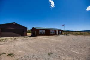 Single story home with an outdoor structure and a garage