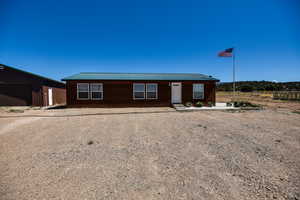 Ranch-style house featuring a metal roof