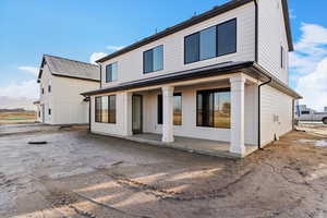 Rear view of property featuring a patio area