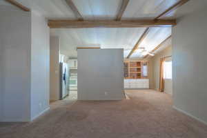 Empty room with light colored carpet and ceiling fan