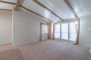 Empty room featuring light carpet and baseboards