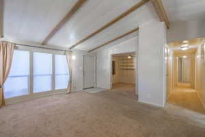 Spare room with light carpet and baseboards