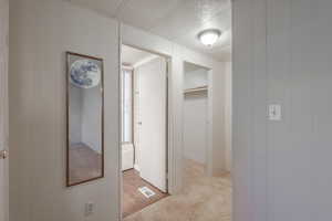 Hallway with light colored carpet