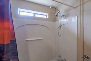 Full bathroom featuring shower / bathtub combination with curtain