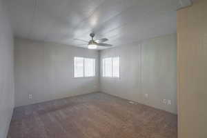 Carpeted spare room with a textured ceiling and a ceiling fan
