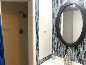 Full bath with a stall shower and vanity
