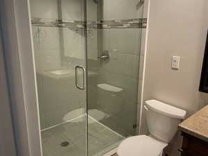 Bathroom featuring vanity and a shower stall